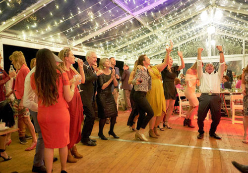 Guests dancing in clear marquees