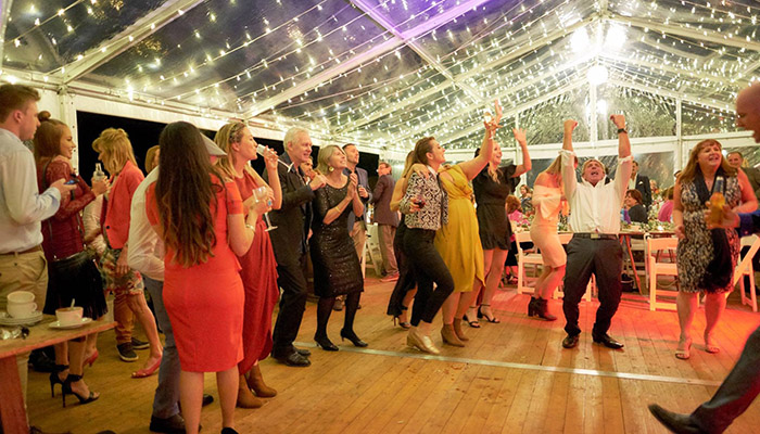 Guests dancing in clear marquees